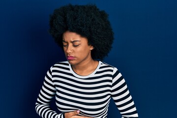 Obraz na płótnie Canvas Young african american woman wearing casual clothes with hand on stomach because indigestion, painful illness feeling unwell. ache concept.