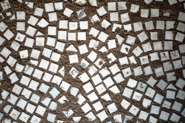 the texture of the tiles on the floor is a mosaic of pieces