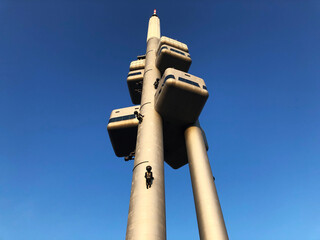 Babies climbing up a television tower