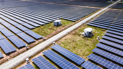 Aerial view of a large scale solar panel farm. It harvesting sun's power to create a flow of electricity. Reduce Reuse and Restore concept