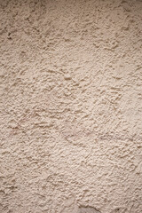 close up beige textured cement and sand wall