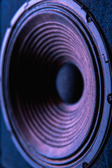 Close-up of speaker membrane on black background.