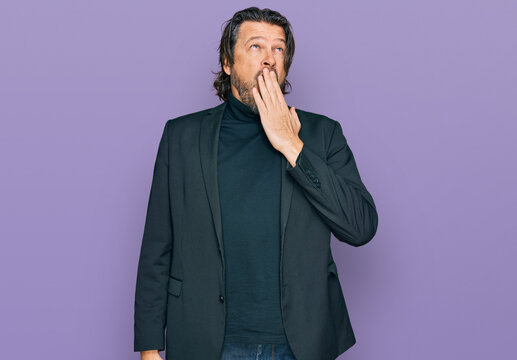 Middle age handsome man wearing business clothes bored yawning tired covering mouth with hand. restless and sleepiness.