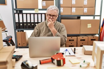 Senior caucasian man working at small business ecommerce with laptop looking confident at the...