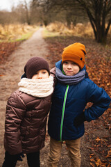 Lifestyle portrait boy and girl in autumn park