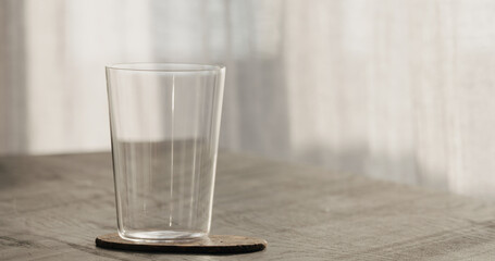 empty tumbler glass on black oak table