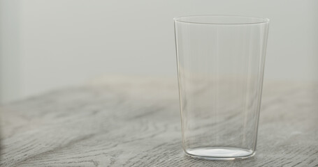 empty tumbler glass on black oak table