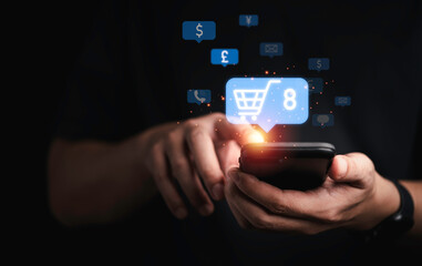 Businessman holding smartphone with shopping trolley cart  to input new order for online shopping concept.