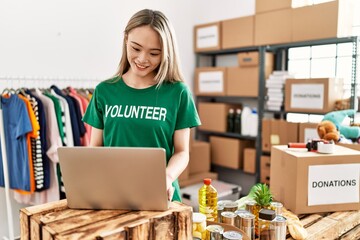Young chinese woman wearing volunteer uniform working at home