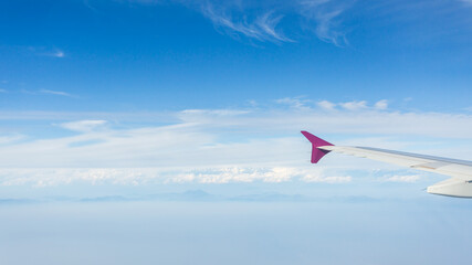 Aerial view of the mountains from the airplane porthole. Travel concept