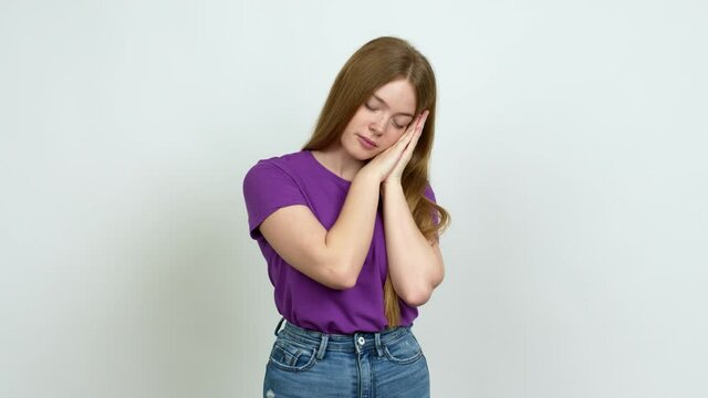 Teenager girl making sleep gesture. Adorable and sweet expression over isolated background