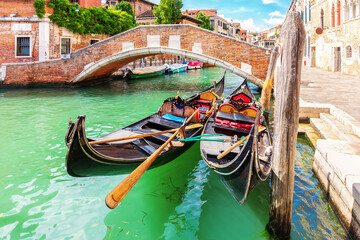 Fototapeta na wymiar Gondolas moored in the Grand Canal of Venice, Italy