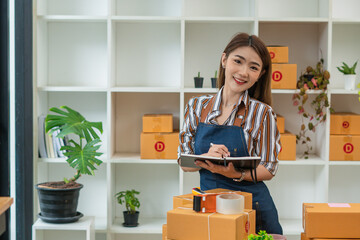 Small Business SME entrepreneur of Young Asian women working with laptop for Online shopping at home,Cheerful and Happy with box for packaging in home,Own Business Start up for Business Online