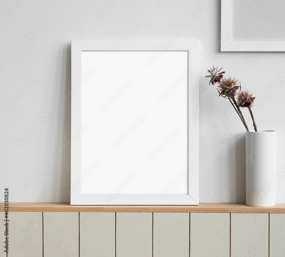 Wall mural blank picture frame mockup on white wall. white living room design. view of modern scandinavian styl