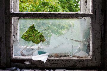 Smashed glass Window with old wooden frame. old window. finely broken glass. old house, retro. cracked window frame. cracked old paint, pieces of glass. close-up, space for text