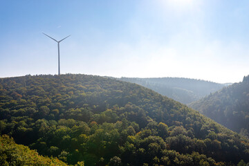 Fototapeta na wymiar Wind turbines for electricity production over a dense forest in western Germany.