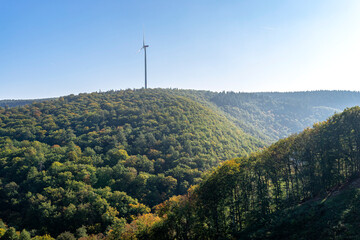 Wind turbines for electricity production over a dense forest in western Germany.