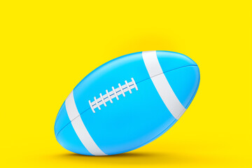 Blue american football ball isolated on yellow background