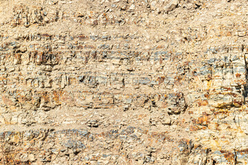 volcanic stone texture. Rock stone side background. White clay rock carrier mountains closeup. For...