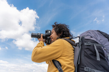 Travel photographer man taking nature photo of mountain landscape
