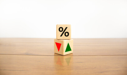 Wooden cubes changes the direction of an arrow symbolizing that the interest rates are going down...