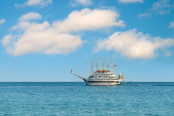 Multi-deck excursion boat taking tourists around on a sunny day