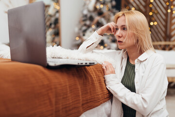 Woman relaxing on the sofa at Christmas.