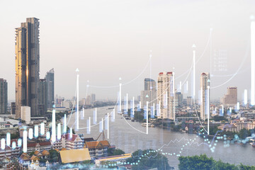 Forex and stock market chart hologram over panorama city view of Bangkok, the financial center in Southeast Asia. The concept of international trading. Double exposure.