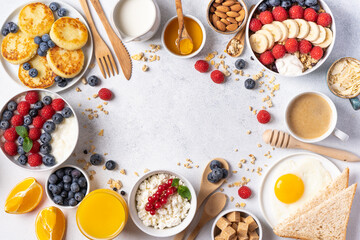 Frame of continental breakfast is captured from above, top view. Coffee, croissants, granola, Belgian waffles, honey, jam. Layout with free text space, copy space