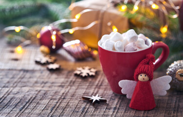 Funny Christmas Angel fir tree branches and gift boxes on winter snowy background with snowy branches. Christmas or Winter concept.