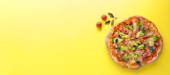 Homemade pizza on a yellow background. View from above. Free space for your text.