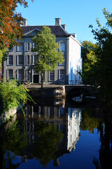 Obraz premium Beautiful canal view. Classic Dutch architecture, autumn trees, water reflections. Fall season in the Netherlands. Amersfoort city view. 