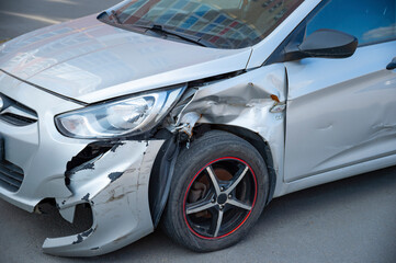 Silver car damaged in a road accident