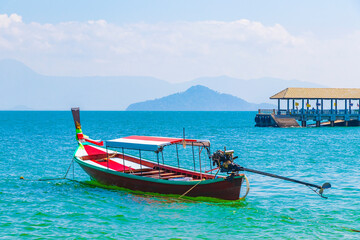 Long-tail boat at pier on island Koh Phayam Thailand.