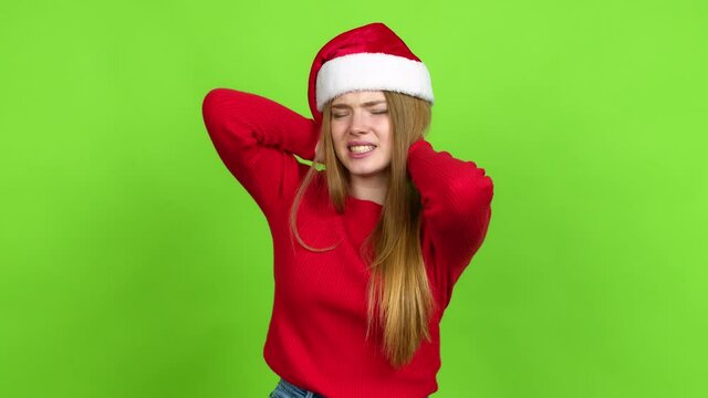 Teenager girl with christmas hat with neck pain over isolated background. Green screen chroma key