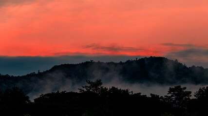 Obraz premium Panoramic nature background (mountains, sea, trees, twilight lights in the sky, waterfront communities), naturally blurred through the wind, seen on tourist spots or scenic spots