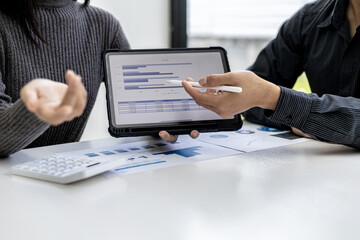 The atmosphere in the conference room was attended by two businessmen, a joint company operating brainstorming meeting for business growth, They are looking at data from the tablet.