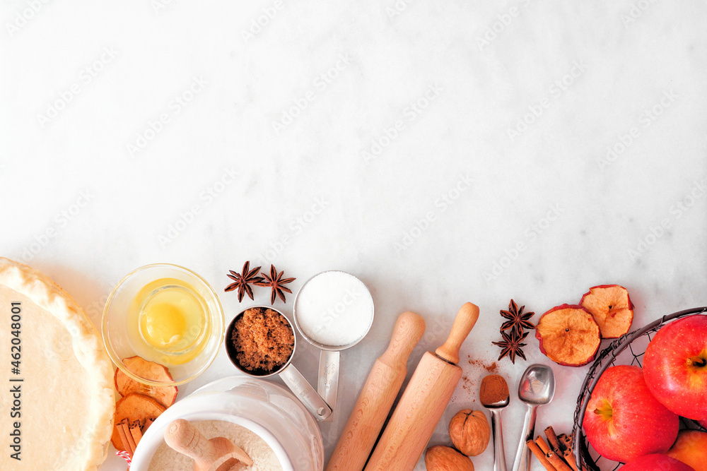 Aufkleber Fall baking bottom border with apple pie ingredients. Top view over a white marble background with copy space.
