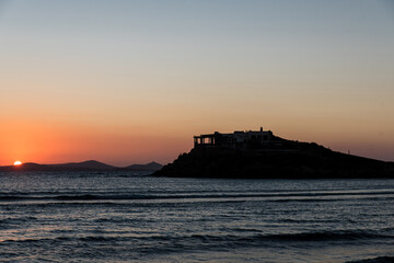 Obraz premium Sunset at Agios Georgios beach in Chora of Naxos island, Cyclades, Greece