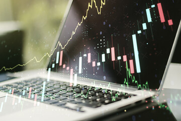 Abstract creative financial graph on modern laptop background, forex and investment concept. Multiexposure