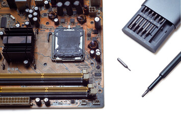 Computer motherboard and screwdriver on white background isolated