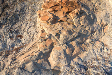 Rock formation on the coast of Dzhanhot (Russia) close-up. Texture, background layers and cracks in sedimentary rock on cliff face. Rock slate in the mountain. Seamless abstract background.