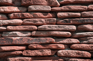 stone background. creative red texture. colored mosaic. wall made of slabs. brick wall in loft style