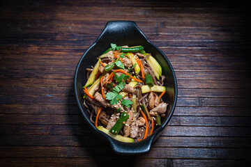 Asian style- restaurant background. Udon noodles with beef Wok