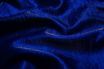 Fototapeta na wymiar Purple shiny fabric as background. Top view.