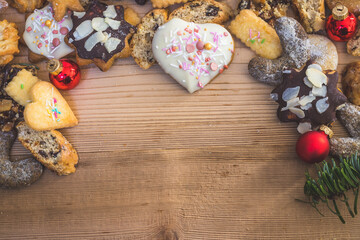 Homemade Christmas cookies: Delicious cookies, powdered sugar and Christmas bauble on rustic wooden table. Copy space.