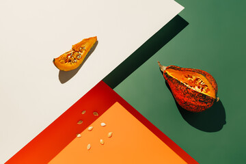Muscat gourde with a cut slice and pulled out seeds on a four-tone background. Minimal composition...