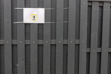security guard sign don`t walk on grey wooden board painted fence