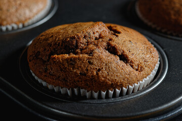 Close up of chocolate muffin in a baking pan