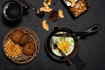 Fried egg in a cast-iron frying pan. Breakfast - kitchen utensils